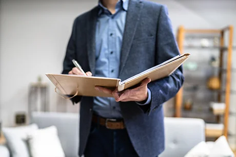 insurance agent writing in notebook