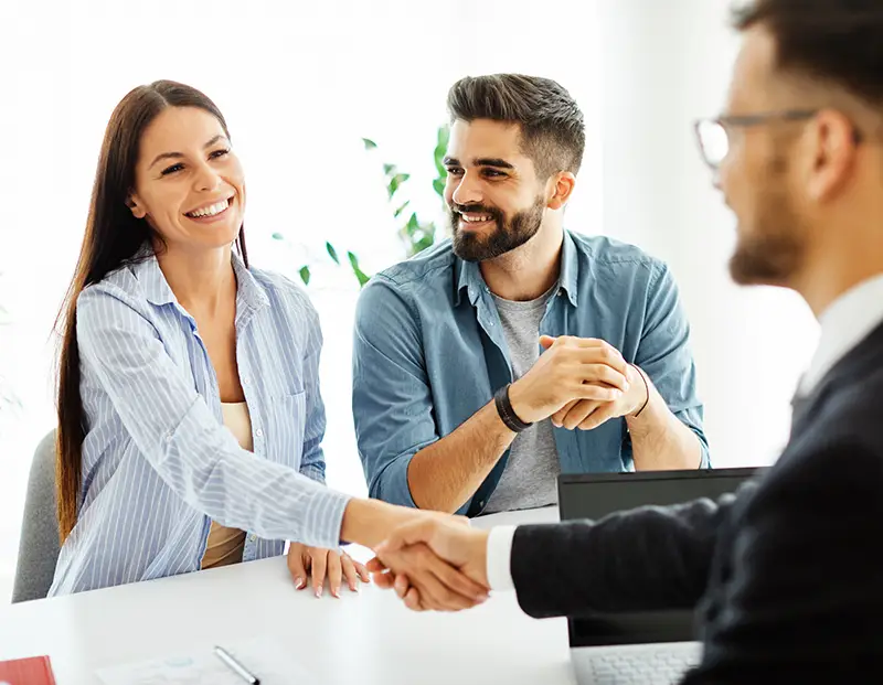 woman shaking hands with insurance agent