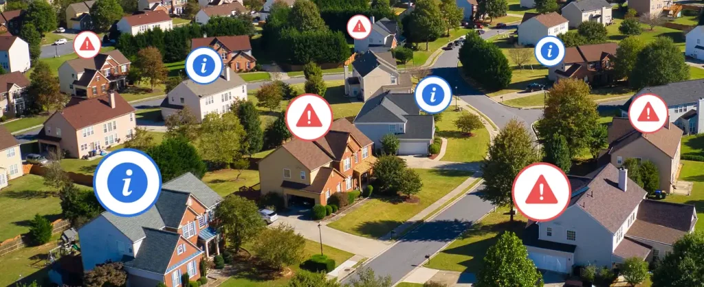 photo of a suburban neighborhood, with alert icons hovering over several of the houses