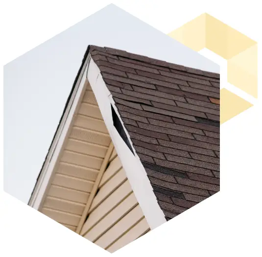 photo of the peak of a home's roof with damage